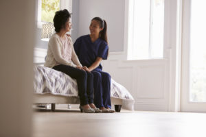 Nurse Making Home Visit To Senior Woman